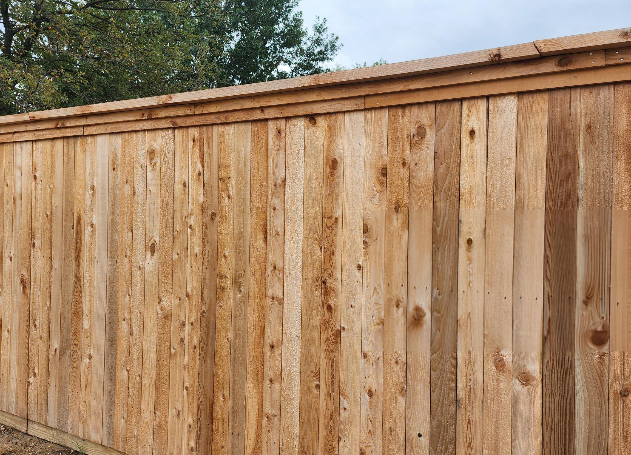 Side view of large stone home with multiple roof pitches and new shingles in Southlake TX