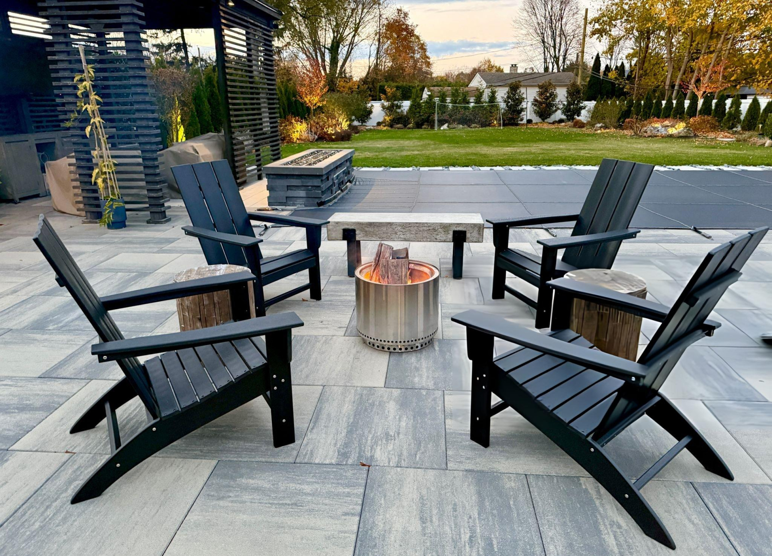 Side view of large stone home with multiple roof pitches and new shingles in Southlake TX