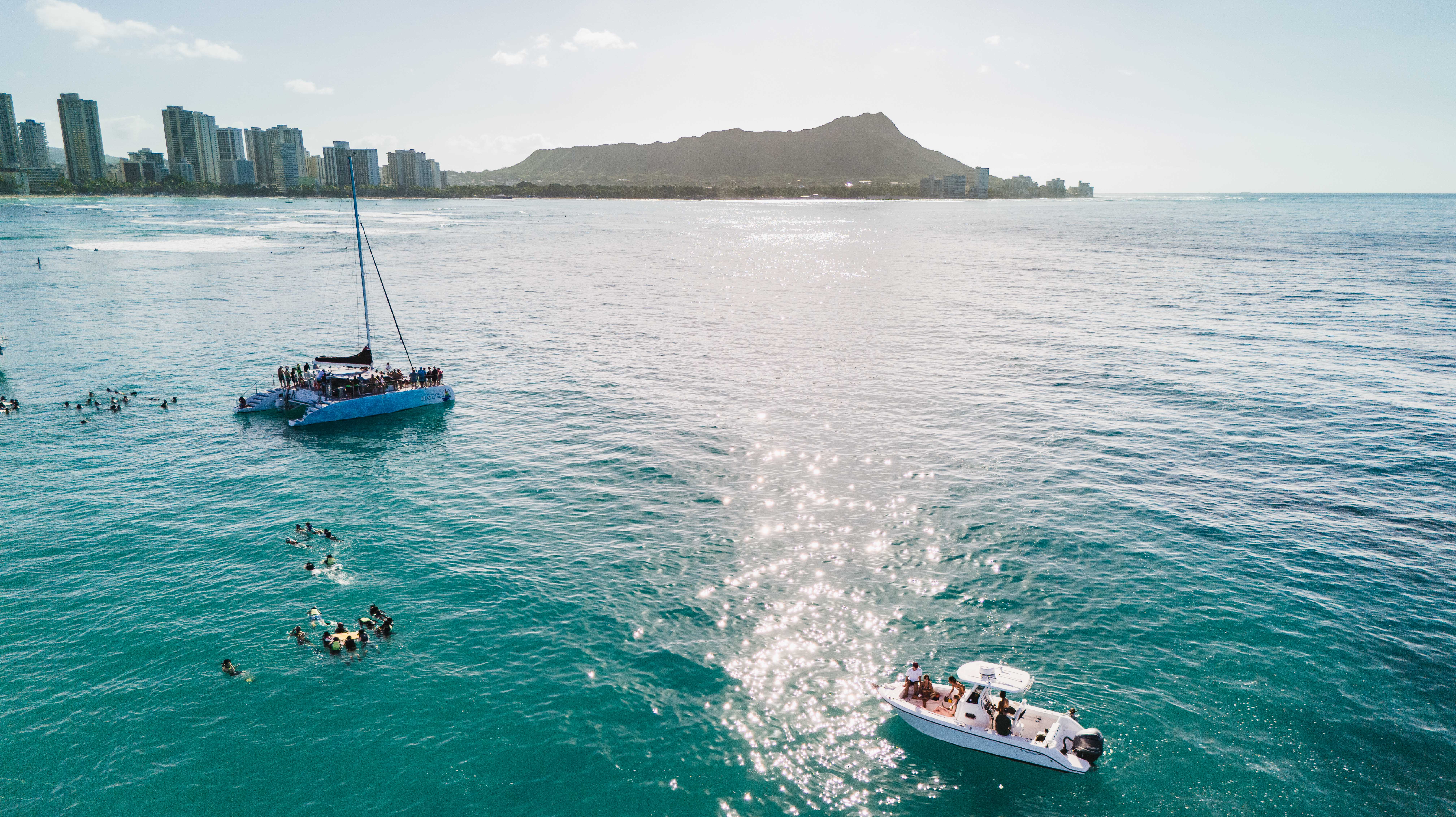 An overhead shot of Turtle Canyon, with the famous Waikiki skyline in the background, prominently featuring Diamond Head (Leahi). 