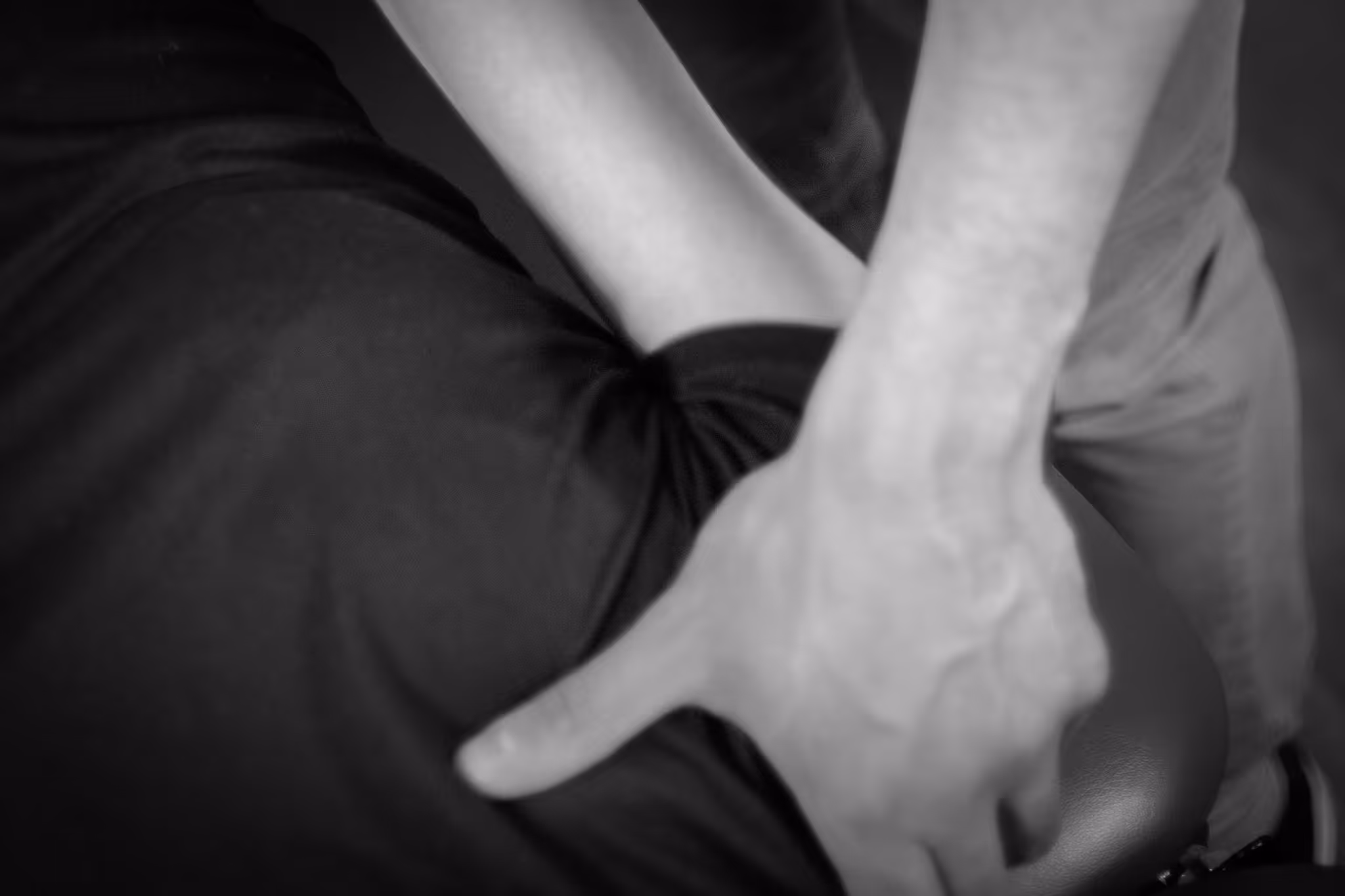Close-up of hands giving a back massage on a person wearing a black shirt.