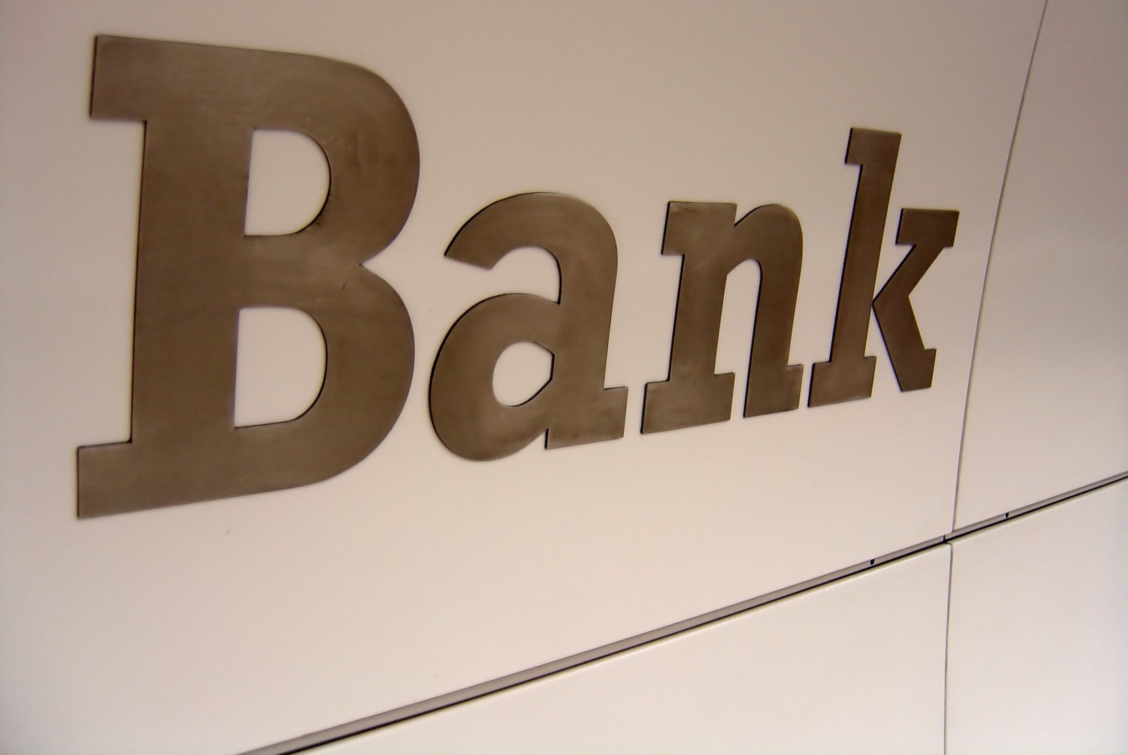 Large metallic letters spelling 'Bank' mounted on a light-colored wall.