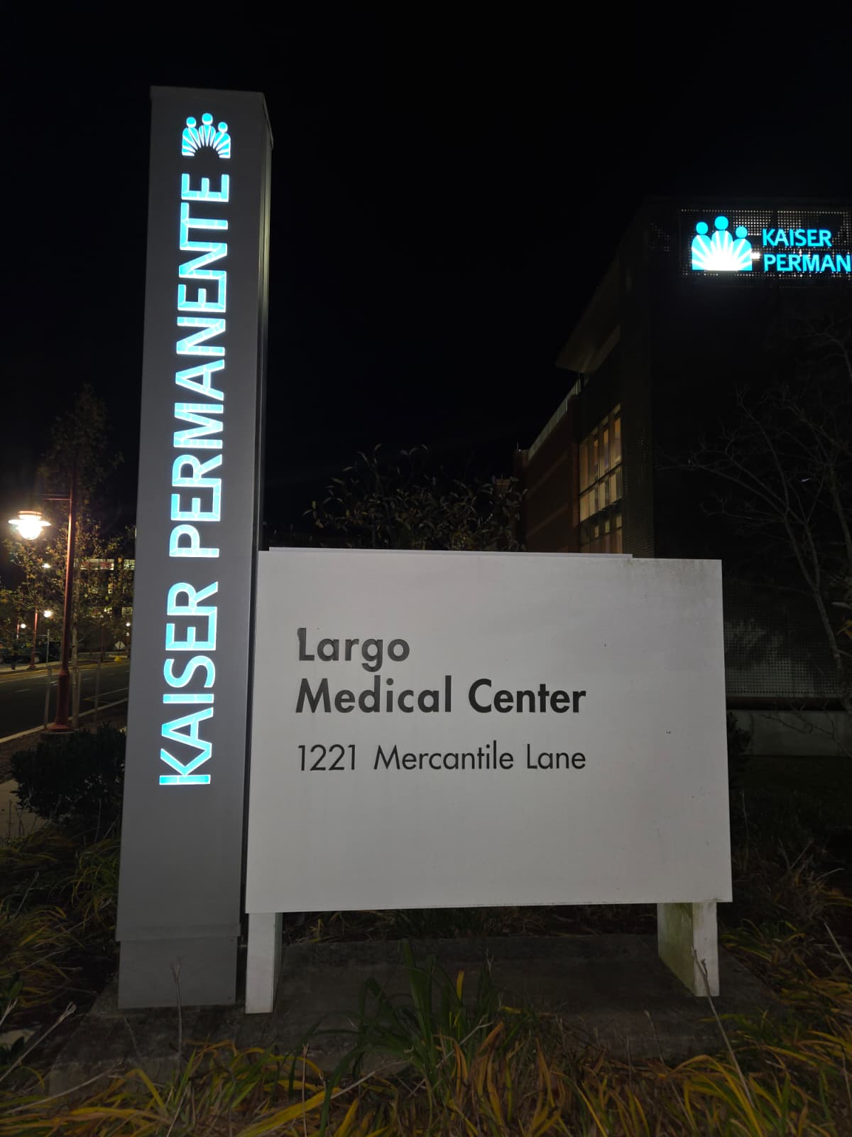 Illuminated sign for Kaiser Permanente Largo Medical Center at 1221 Mercantile Lane at night.
