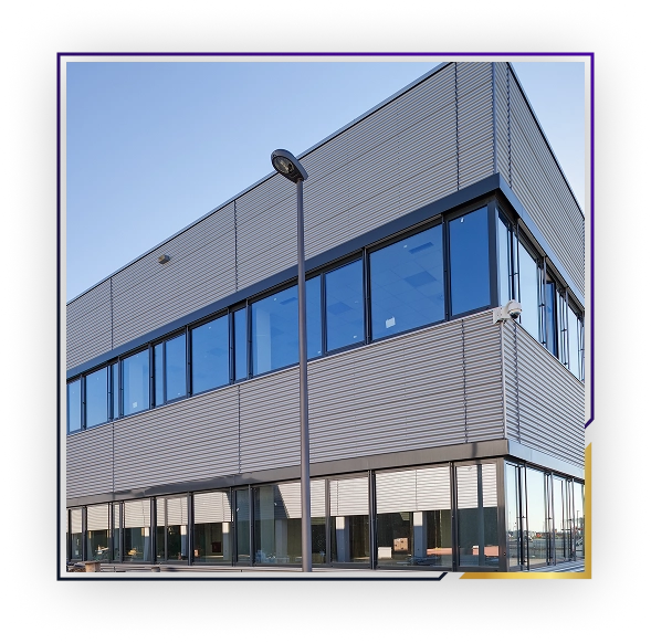 Modern two-story commercial building with large glass windows and a streetlamp in front.
