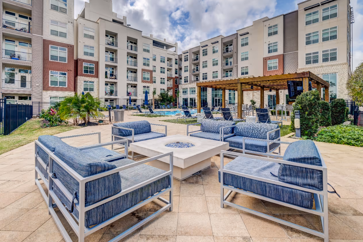 Chairs and fire pit near cabana near pool