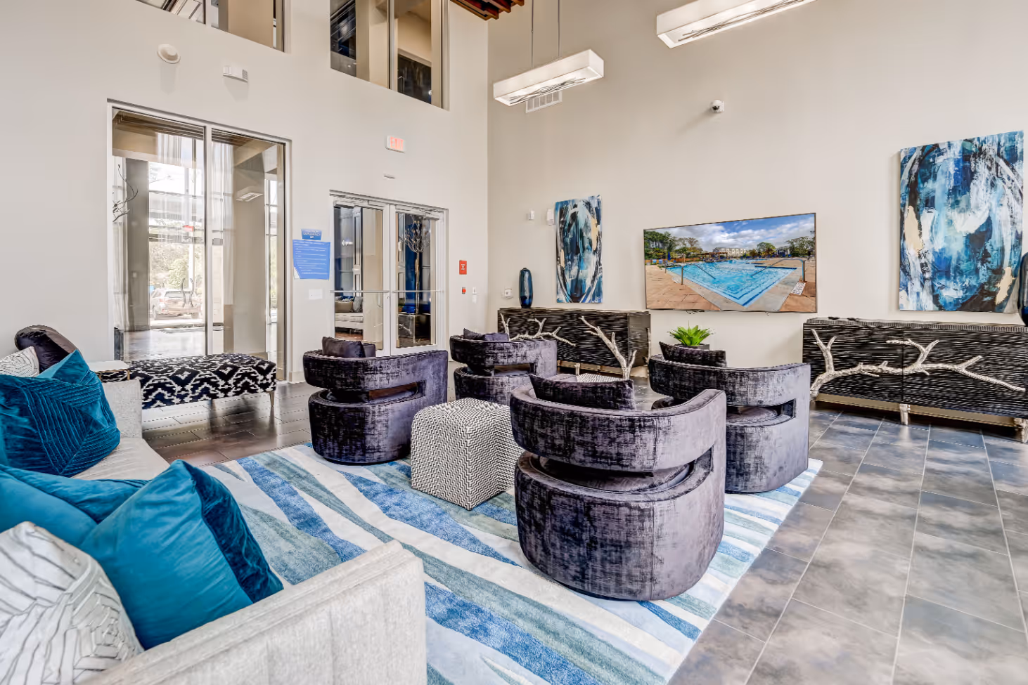 Community lounge with sofa, chairs, and tv