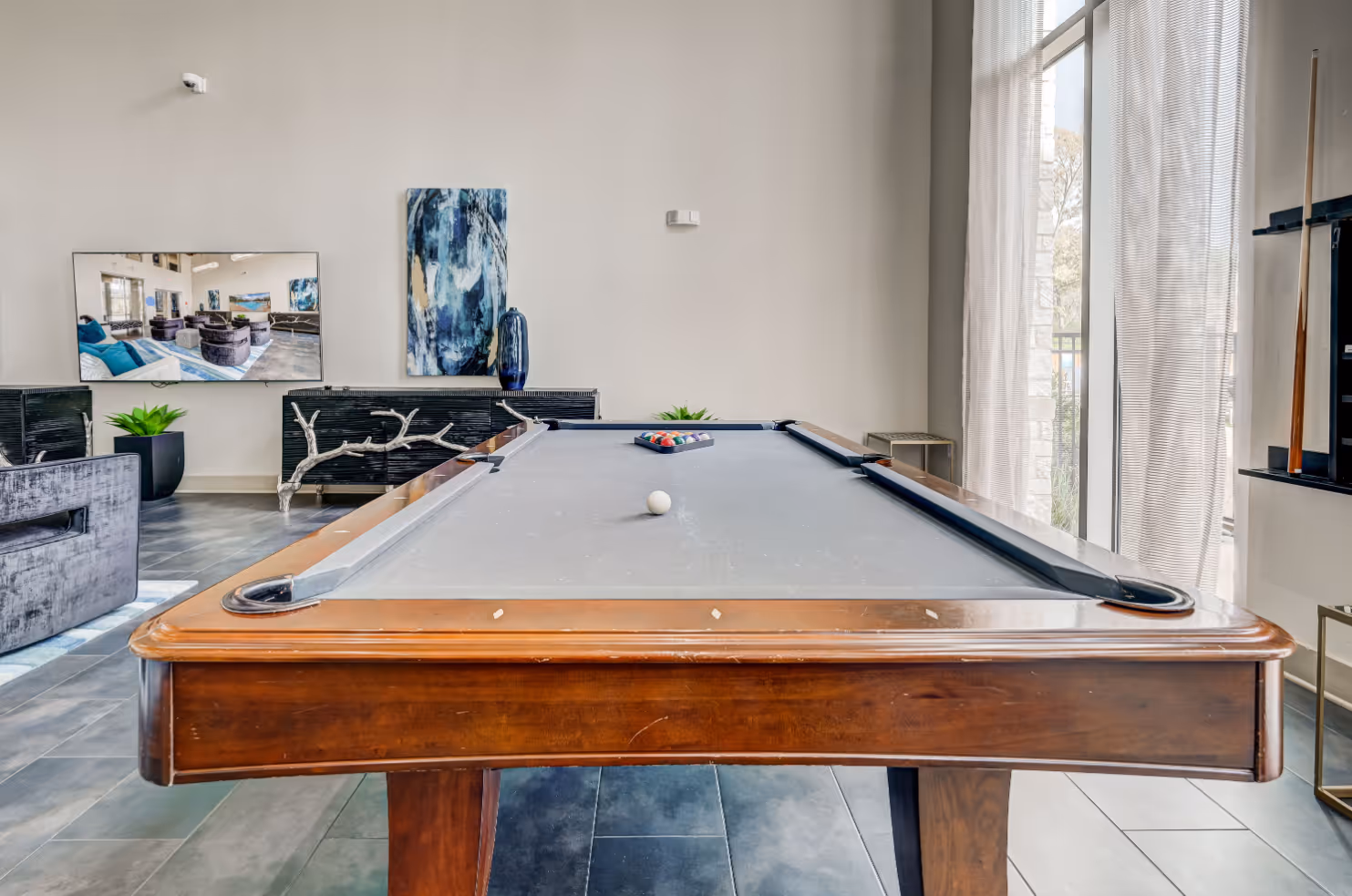 Community lounge game room with billiards table