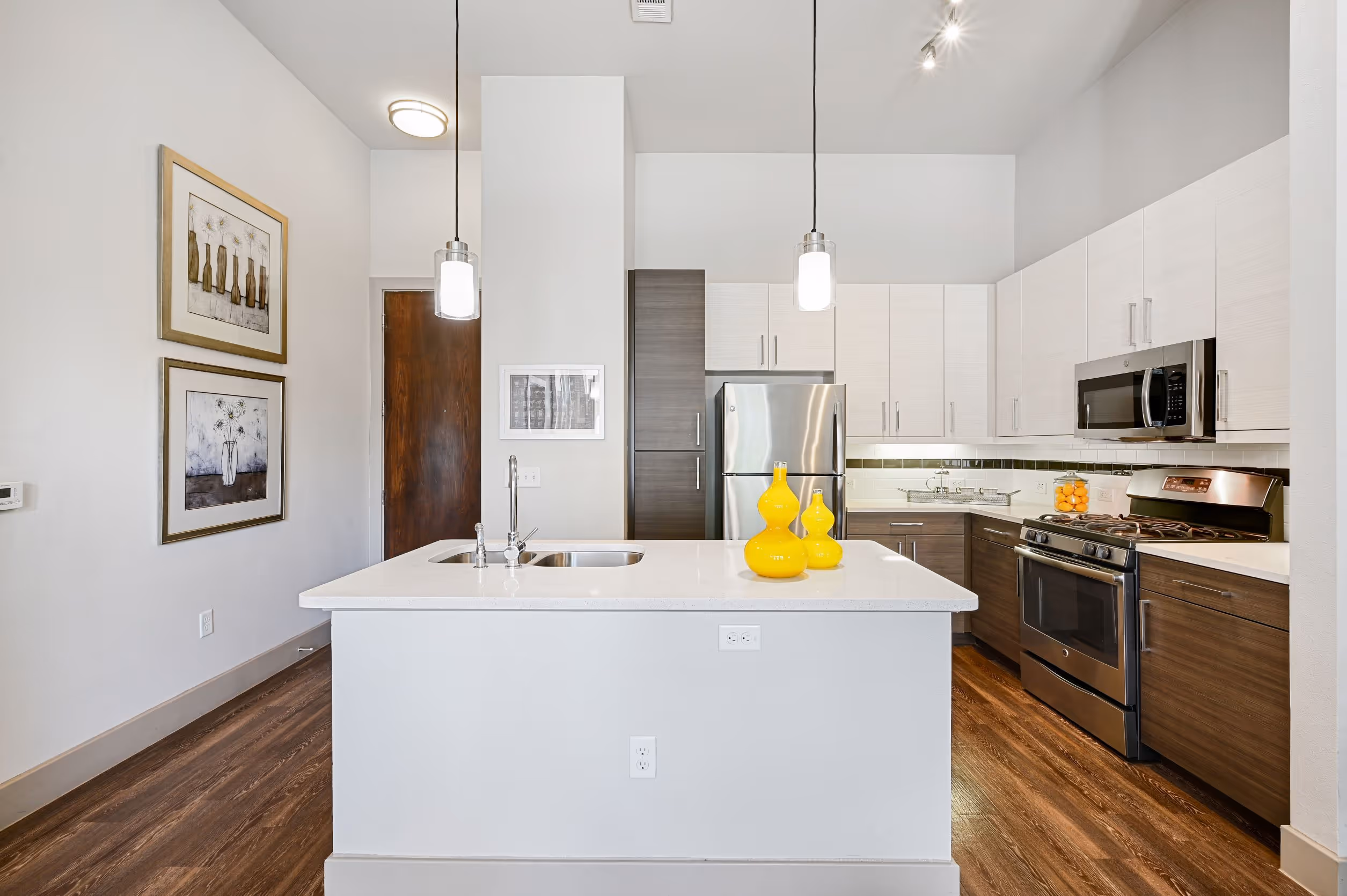 Kitchen with island, stainless steel appliances and white cabinets