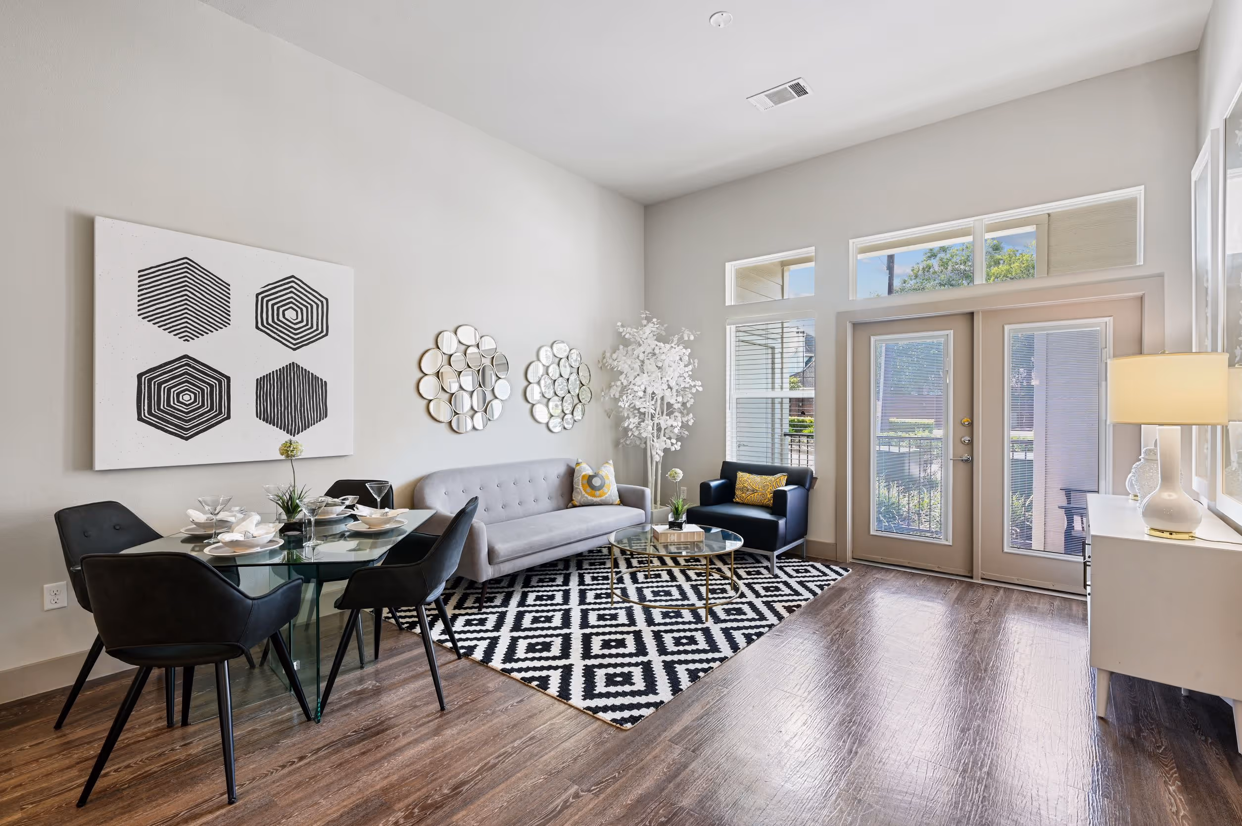 Living area with sofa and view of dining area with table and chairs