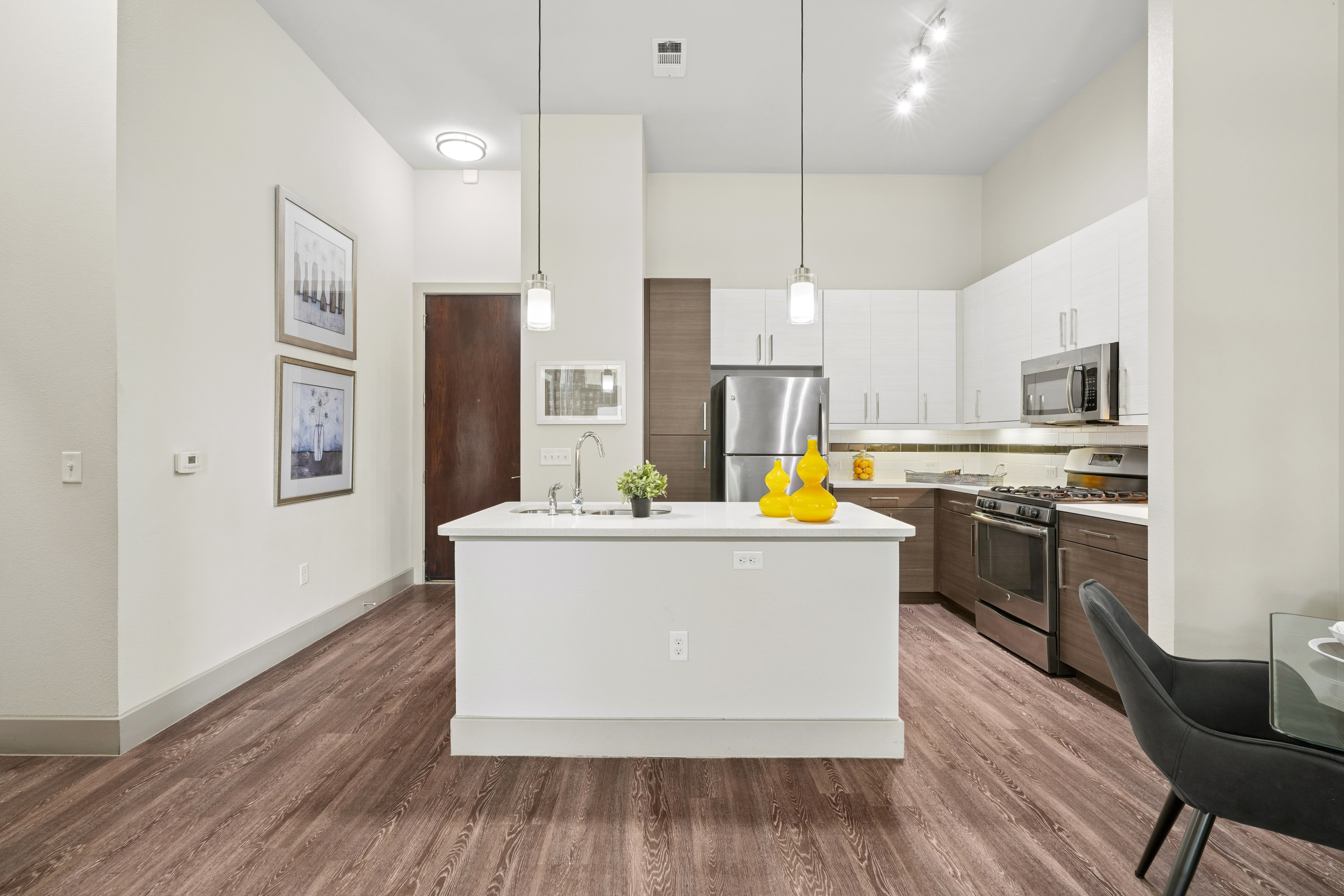 Kitchen with stainless steel appliances and brown and white cabinets