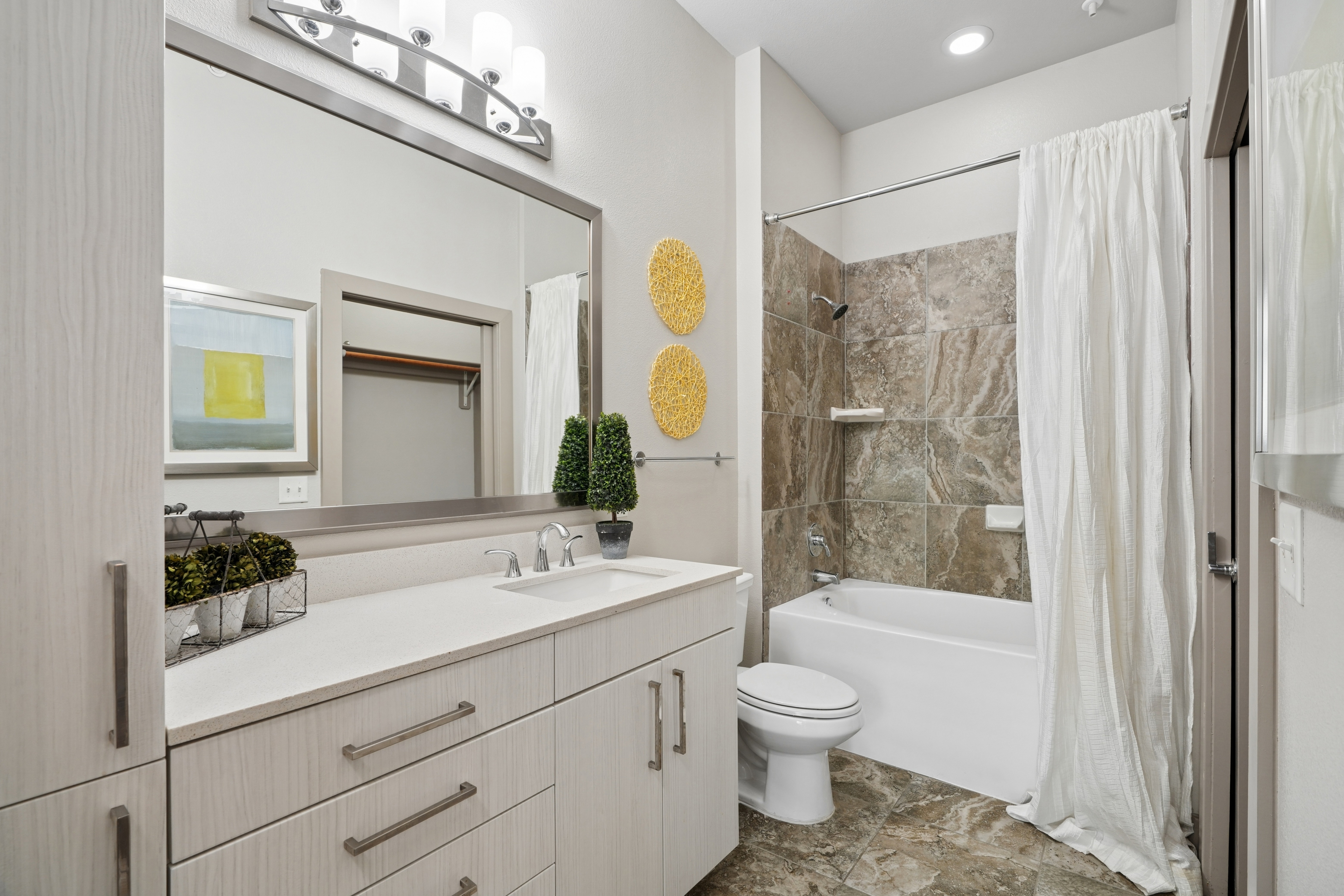 Bathroom with spacious cabinets and relaxing soaking garden tub