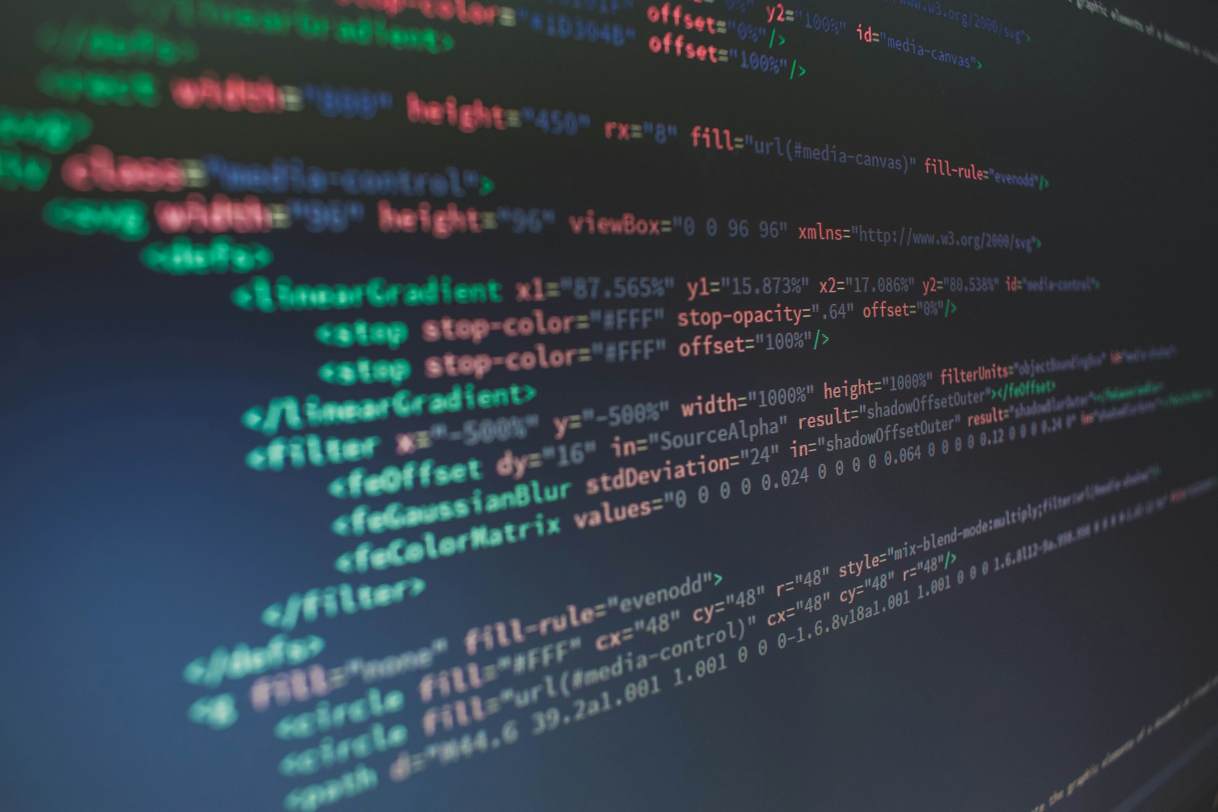 Glowing lines of HTML code on a dark monitor, representing AI agents picking up developer work assigned from Jira to Cursor. Photo by Florian Olivo on Unsplash.