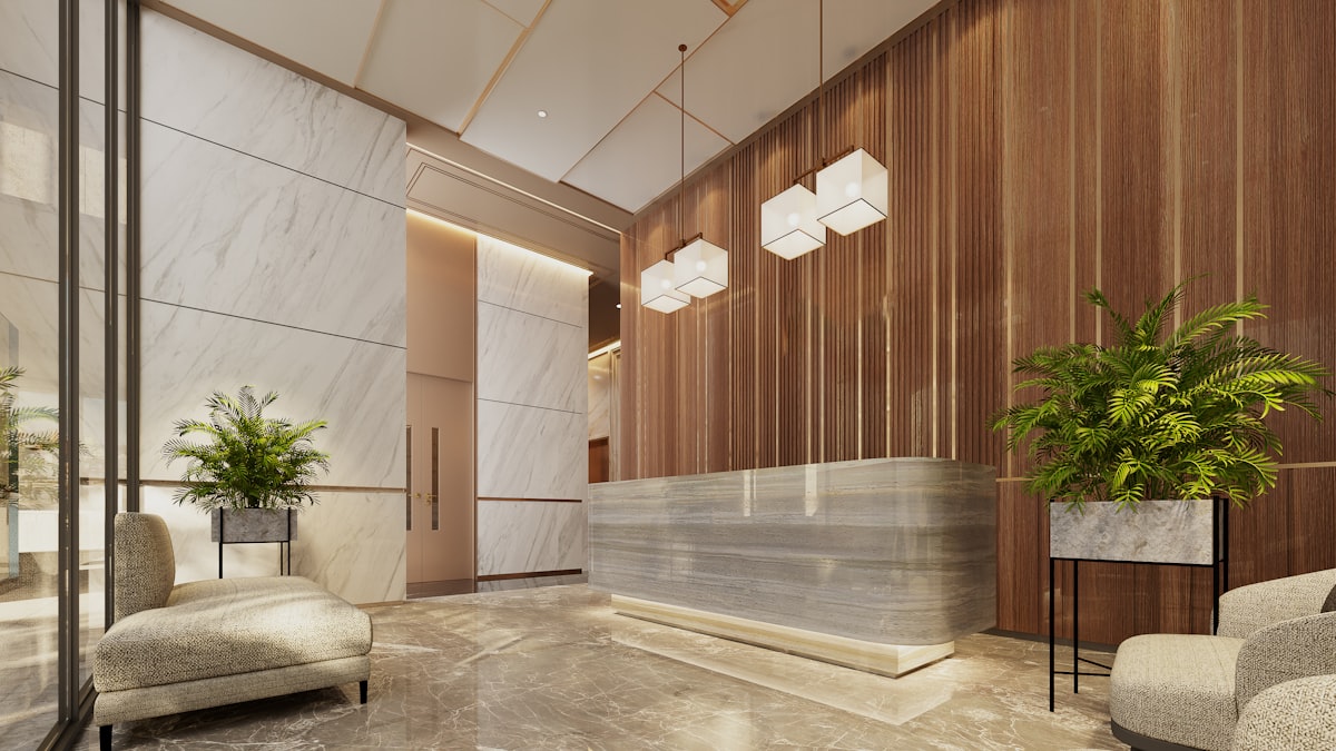 A warm, modern office lobby with a reception desk and greenery, the welcoming front door of a Confluence-powered company intranet. Photo from Unsplash.