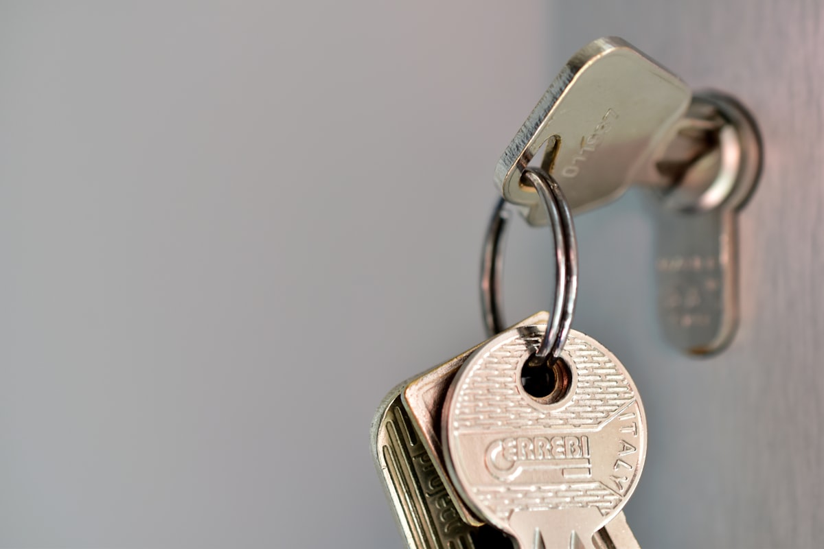 A row of assorted keys hanging on individual hooks, illustrating granular per-environment and per-package permissions in Bitbucket rather than one master key. Photo from Unsplash.