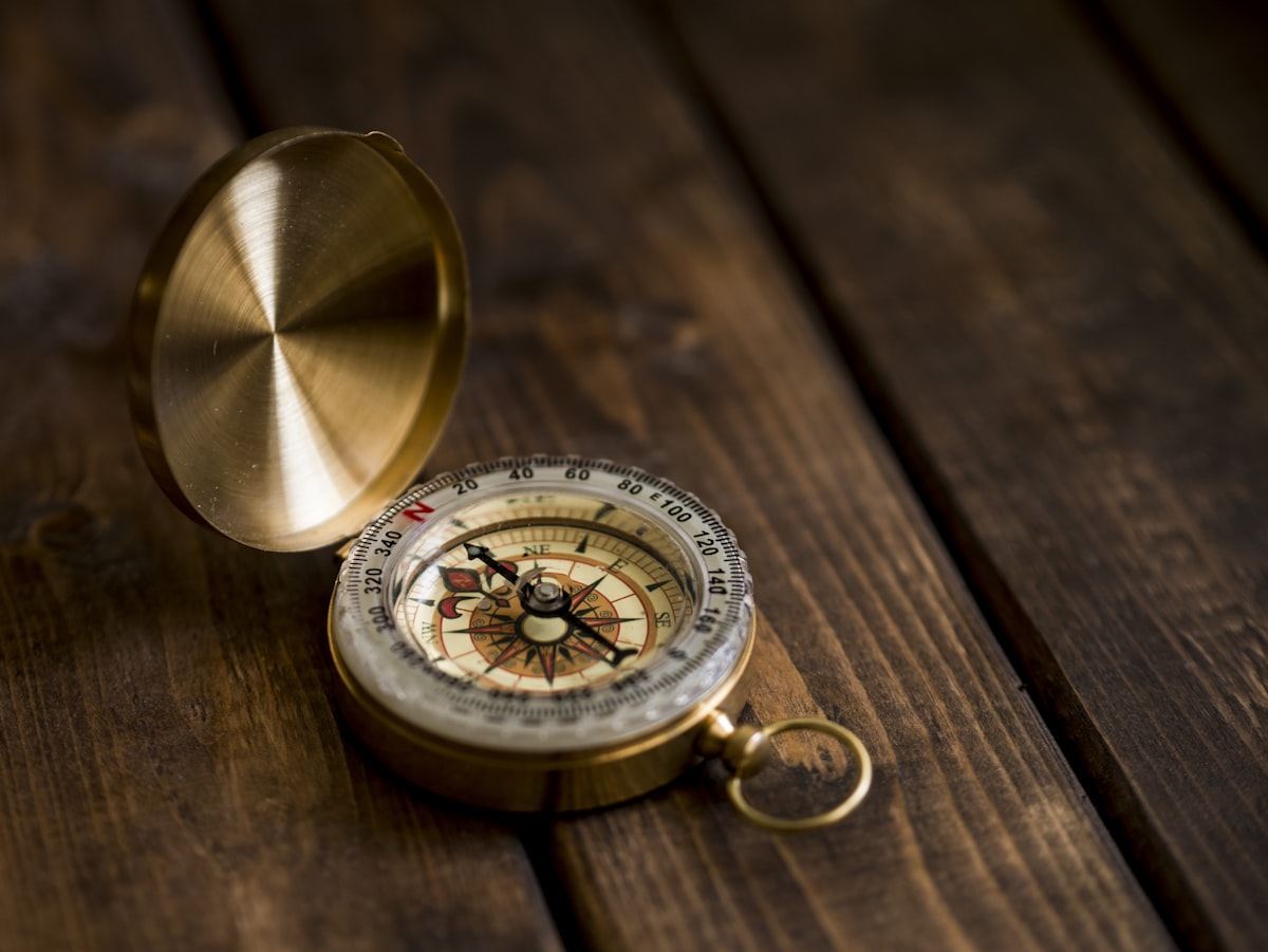 A vintage brass compass resting on a wooden surface, illustrating analyst reports as directional guidance rather than a destination for ITSM platform decisions. Photo from Unsplash.