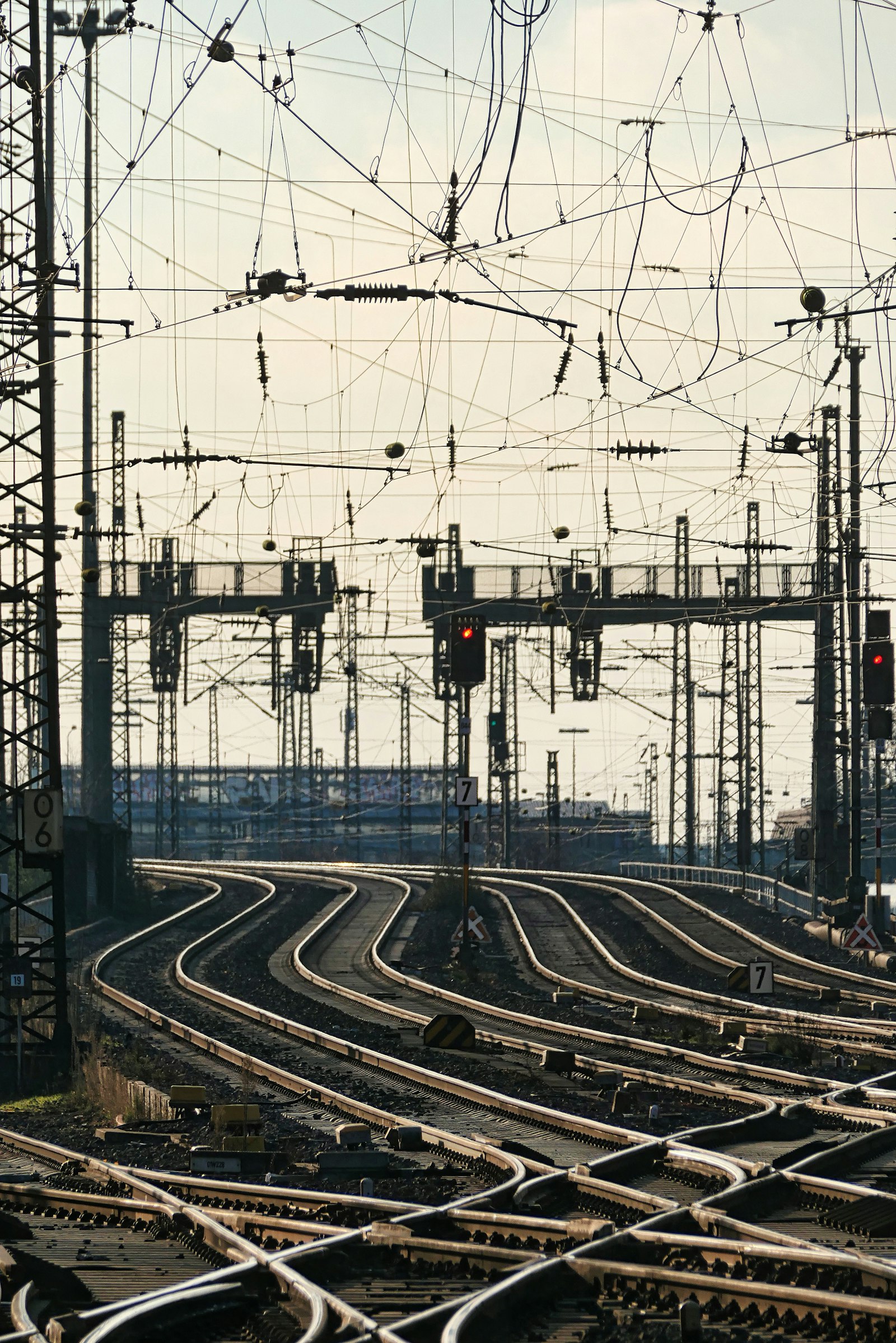 Rail yard tracks converging through switches and signal lines