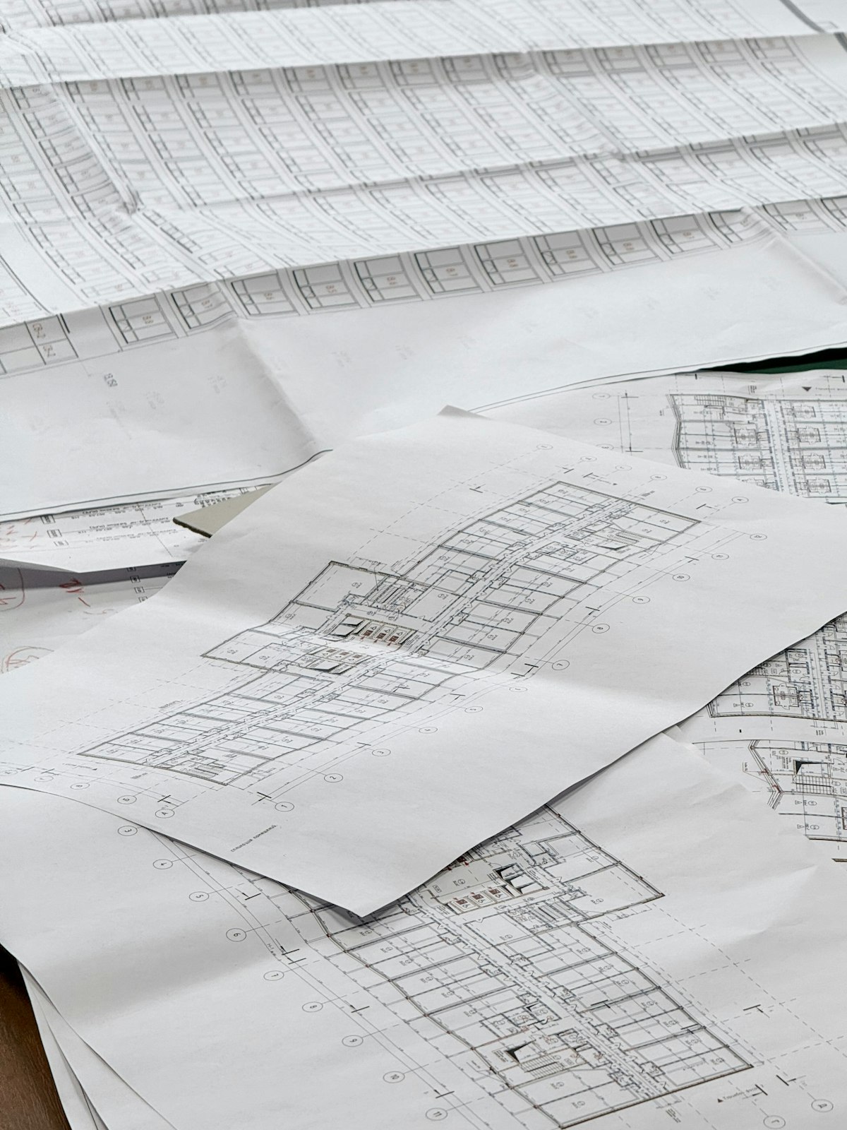 Architectural blueprints spread across a work surface before construction begins