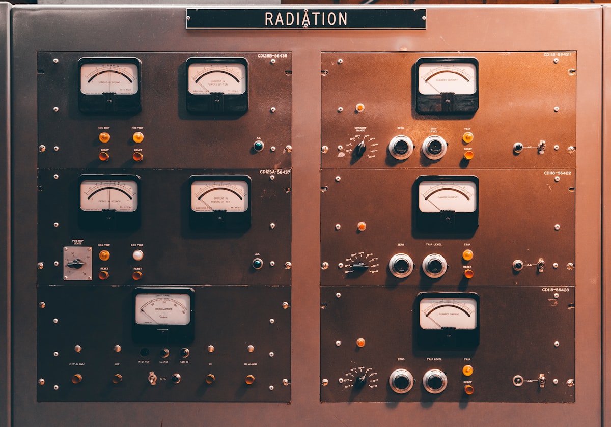 Rows of analog gauges and dials on a vintage industrial control panel