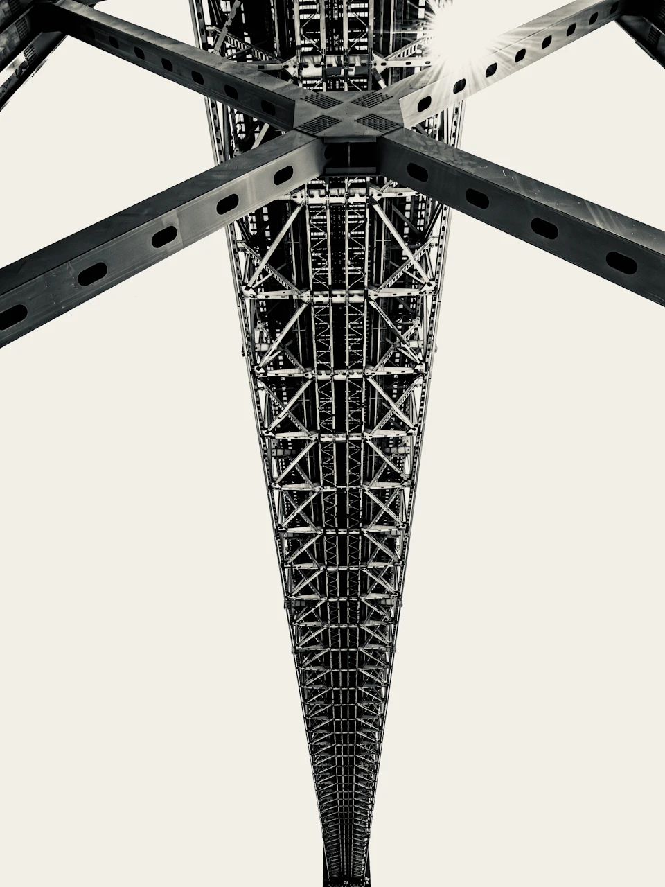Interconnected structural beams beneath a steel bridge