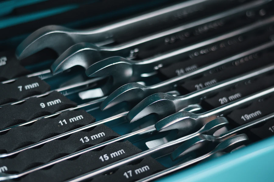 A selection of metal wrenches arranged in a toolbox