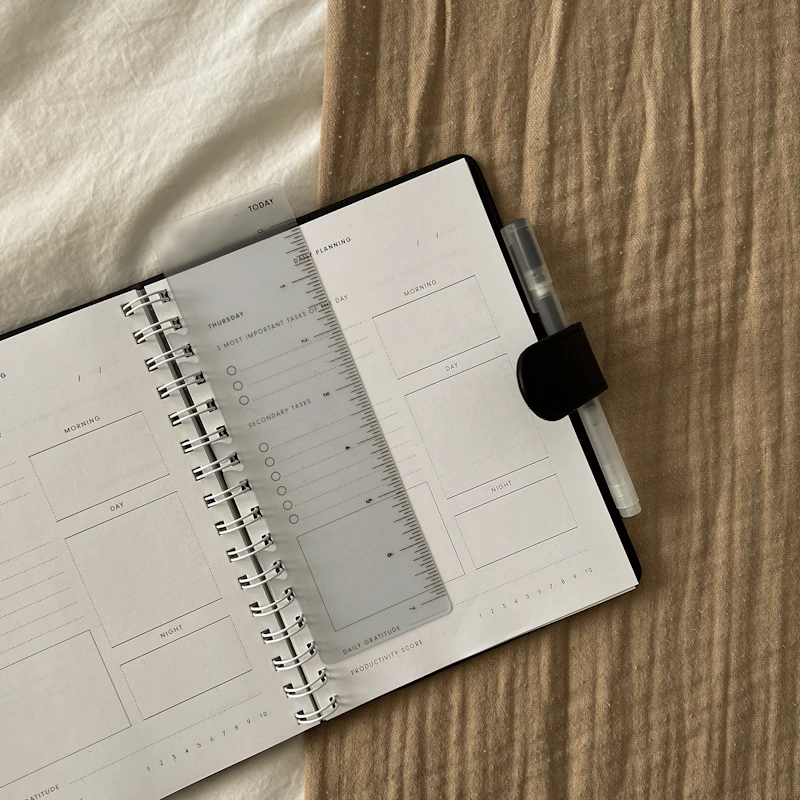 An open daily planner with spaces for morning and afternoon activities
