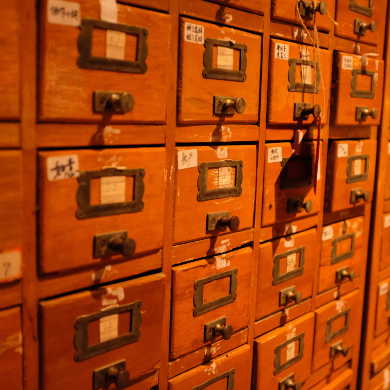 Labelled wooden drawers arranged in a filing system