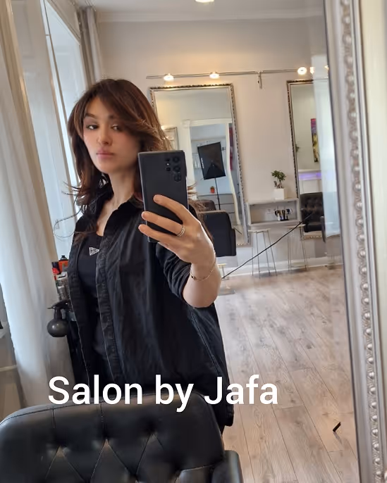 Friseurin beim professionellen Haarschnitt im Salon