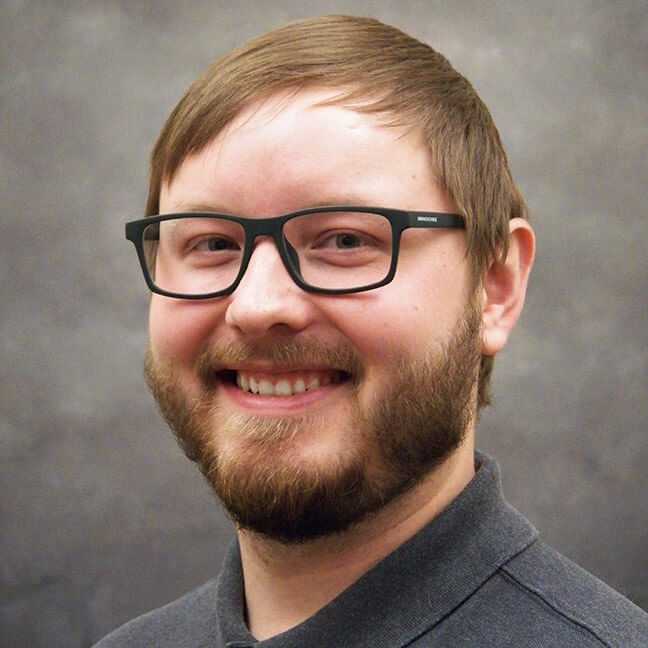 Smiling IT consultant in glasses representing Systems Tech Consultant MSP team in Billings MT
