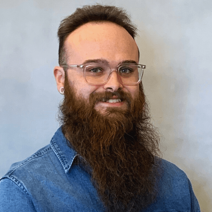 Smiling IT consultant with beard and glasses in denim shirt, Systems Tech Consultant Billings MT team member
