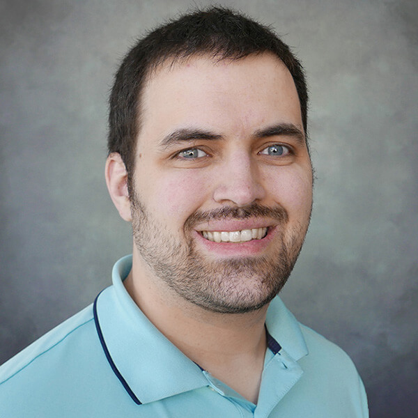 Smiling IT consultant in light blue polo, professional headshot for Billings MT managed services provider
