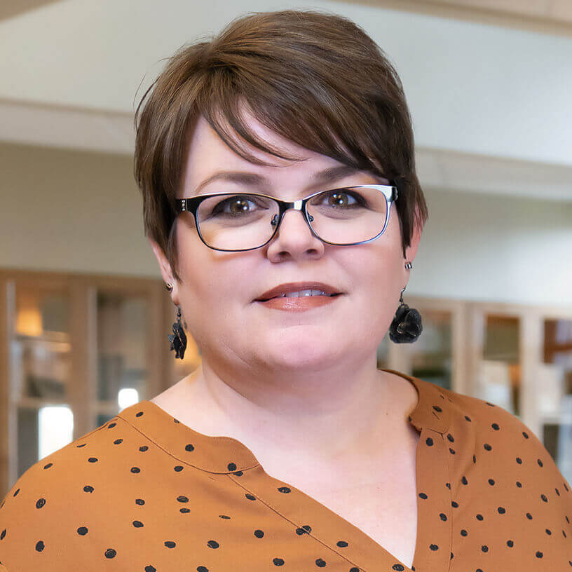 Woman smiling in office environment, IT professional at Systems Tech Consultant MSP in Billings MT