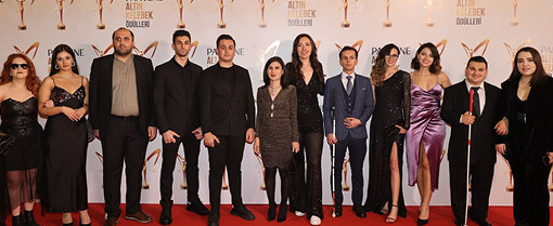 BlindLook team posing together on the red carpet at an awards event.