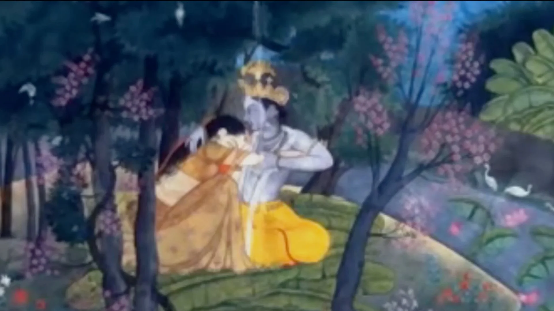 Traditional painting of the Hindu deities Krishna and Radha embracing in a lush forest with blooming trees and swans nearby.