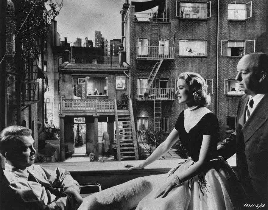 James Stewart, Grace Kelly, and Hitchcock on the set of Rear Window, 1954.
