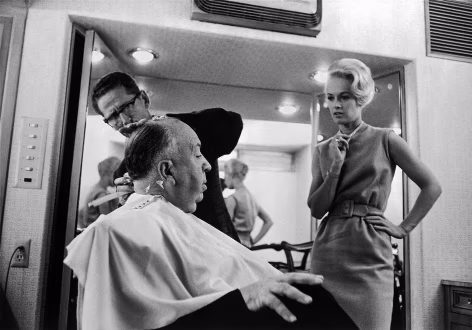 Hitchcock getting a haircut on the set of The Birds, 1963