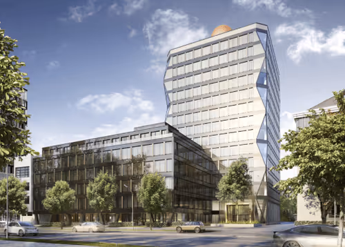 Modern office buildings with glass facades surrounded by trees under a partly cloudy sky.