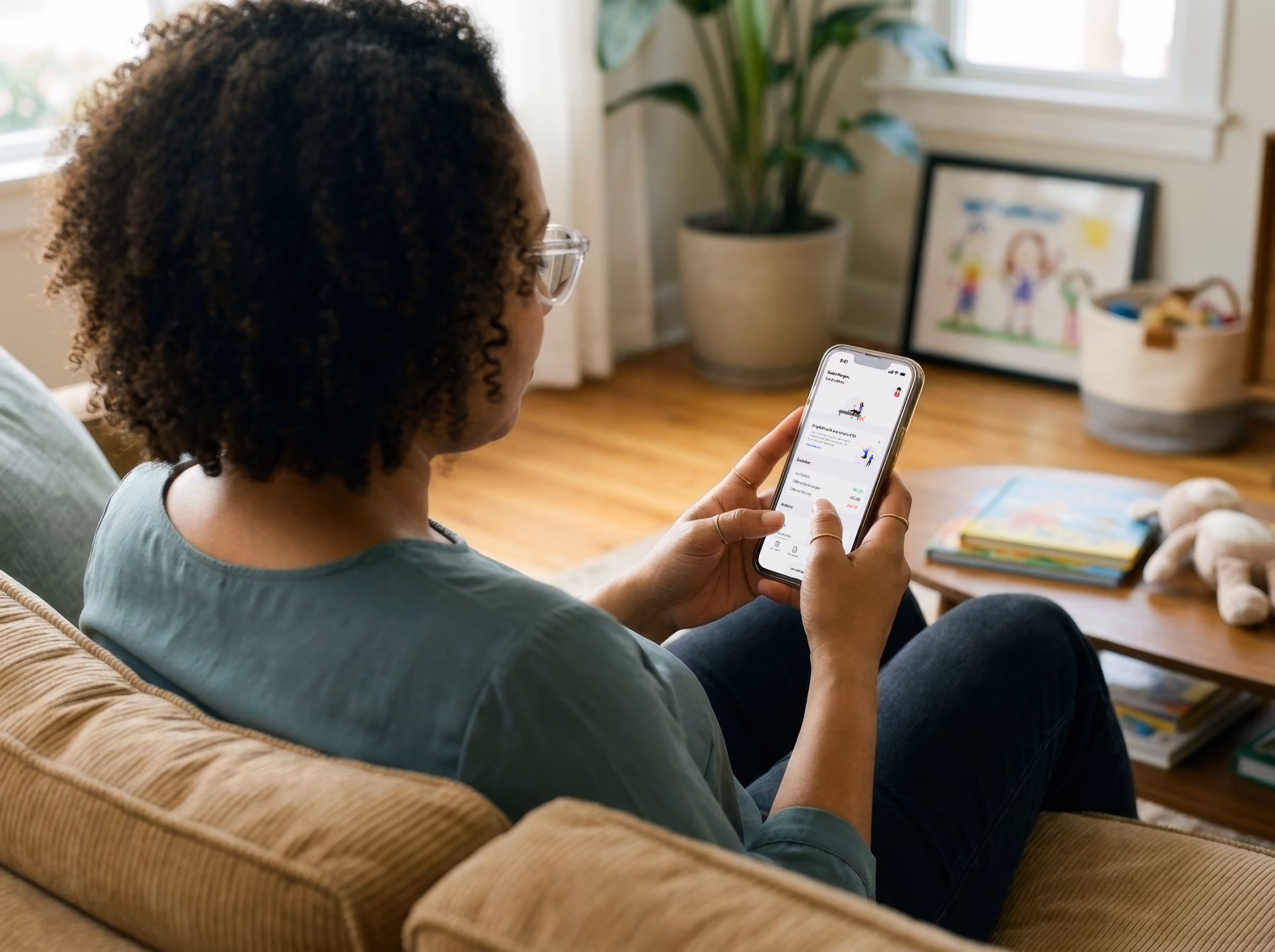 Woman sitting on a couch using an app on her smartphone in a living room setting.
