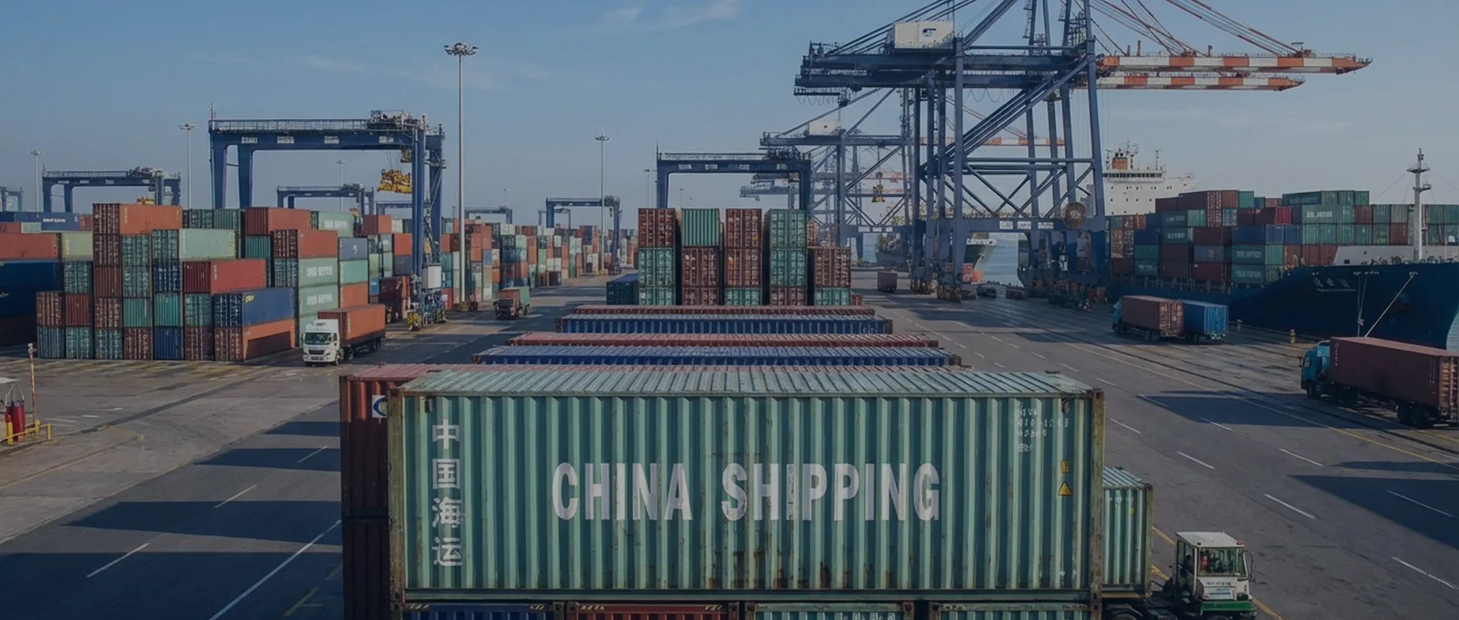 Shipping port with numerous stacked cargo containers and large cranes, featuring a container labeled China Shipping in the foreground.
