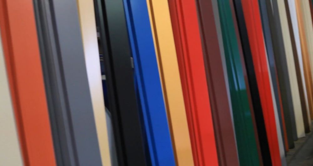 Close-up of vertically arranged metal panels in various colors including blue, red, green, and gray.