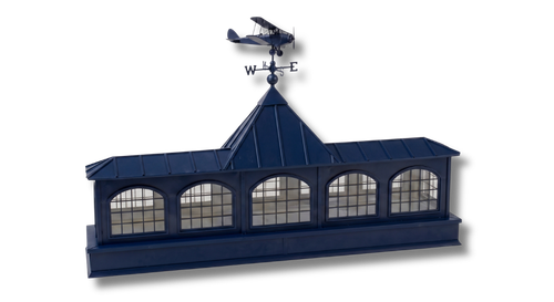 Blue rooftop cupola with four arched windows and an airplane weather vane on top.