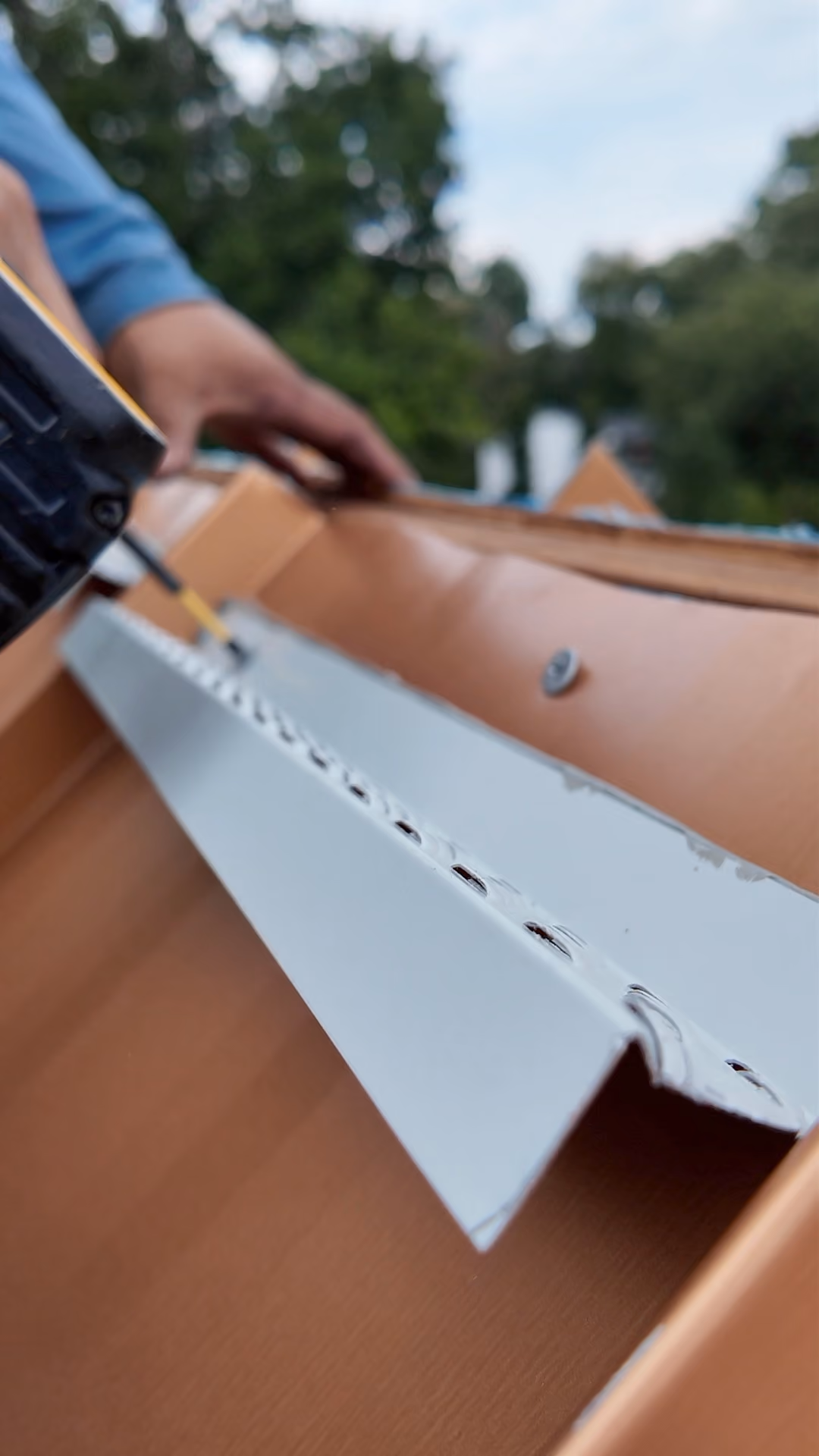 Installing z bar closure at the ridge of a standing seam metal roof