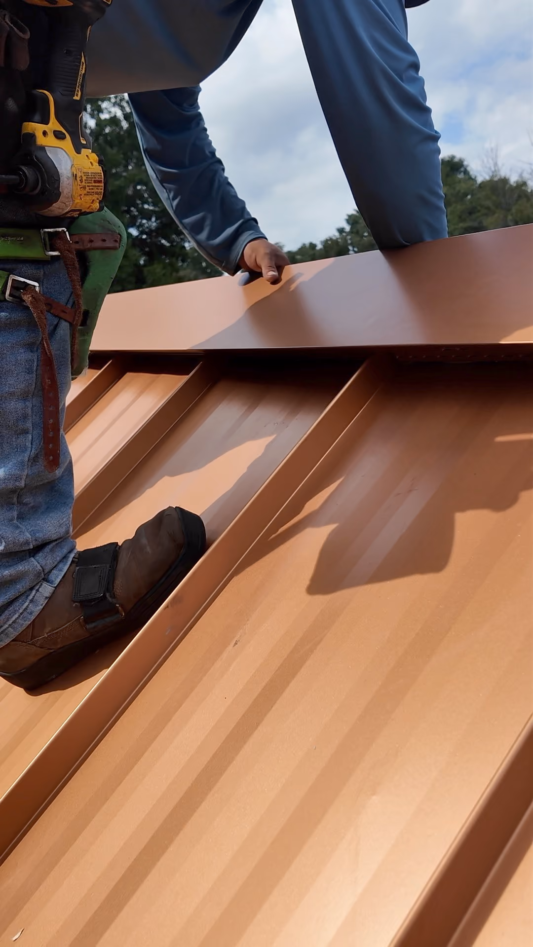 Snapping a ridge cap onto a standing seam metal roof