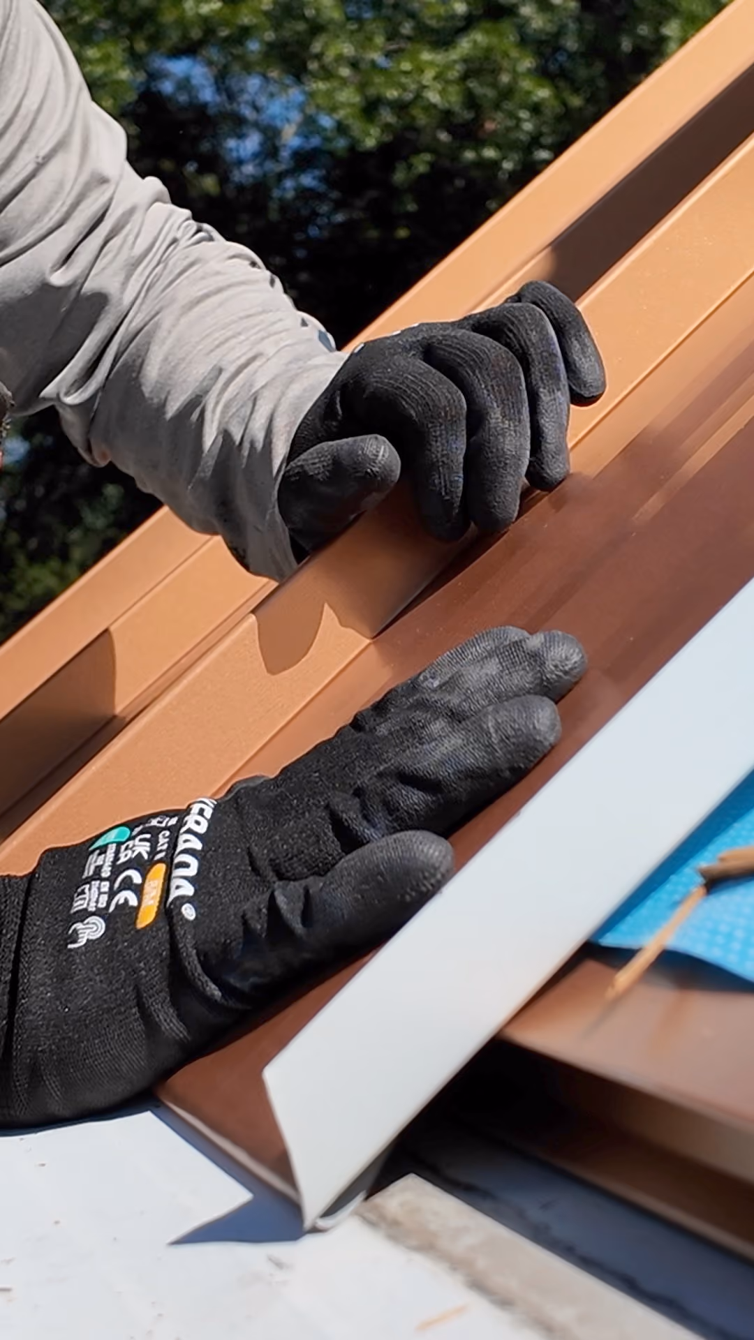 Snapping a standing seam metal panel into the adjacent panel lock