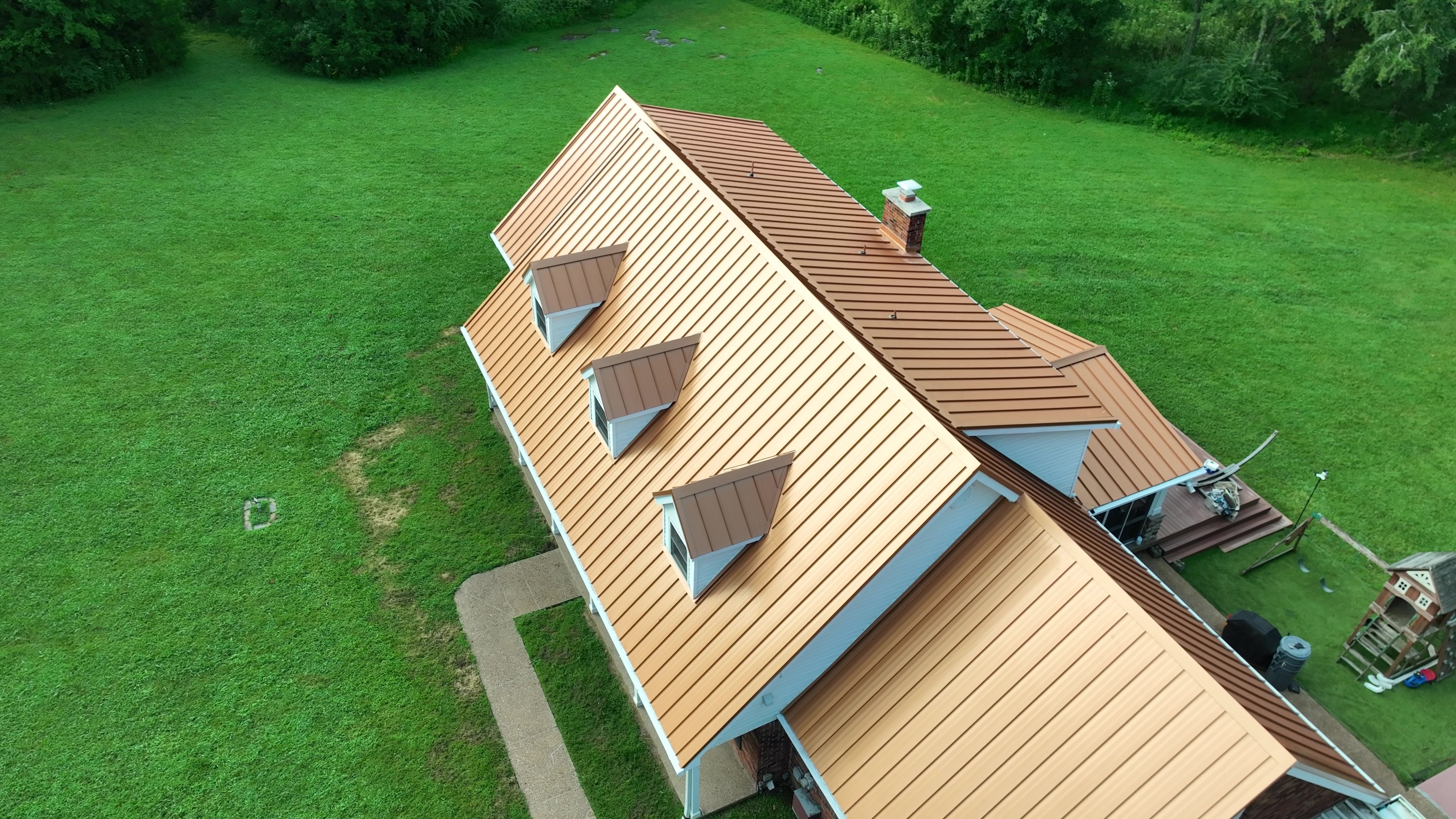 Overhead view of a copper penny standing seam metal roof with three dormers in Lebanon, Tennessee