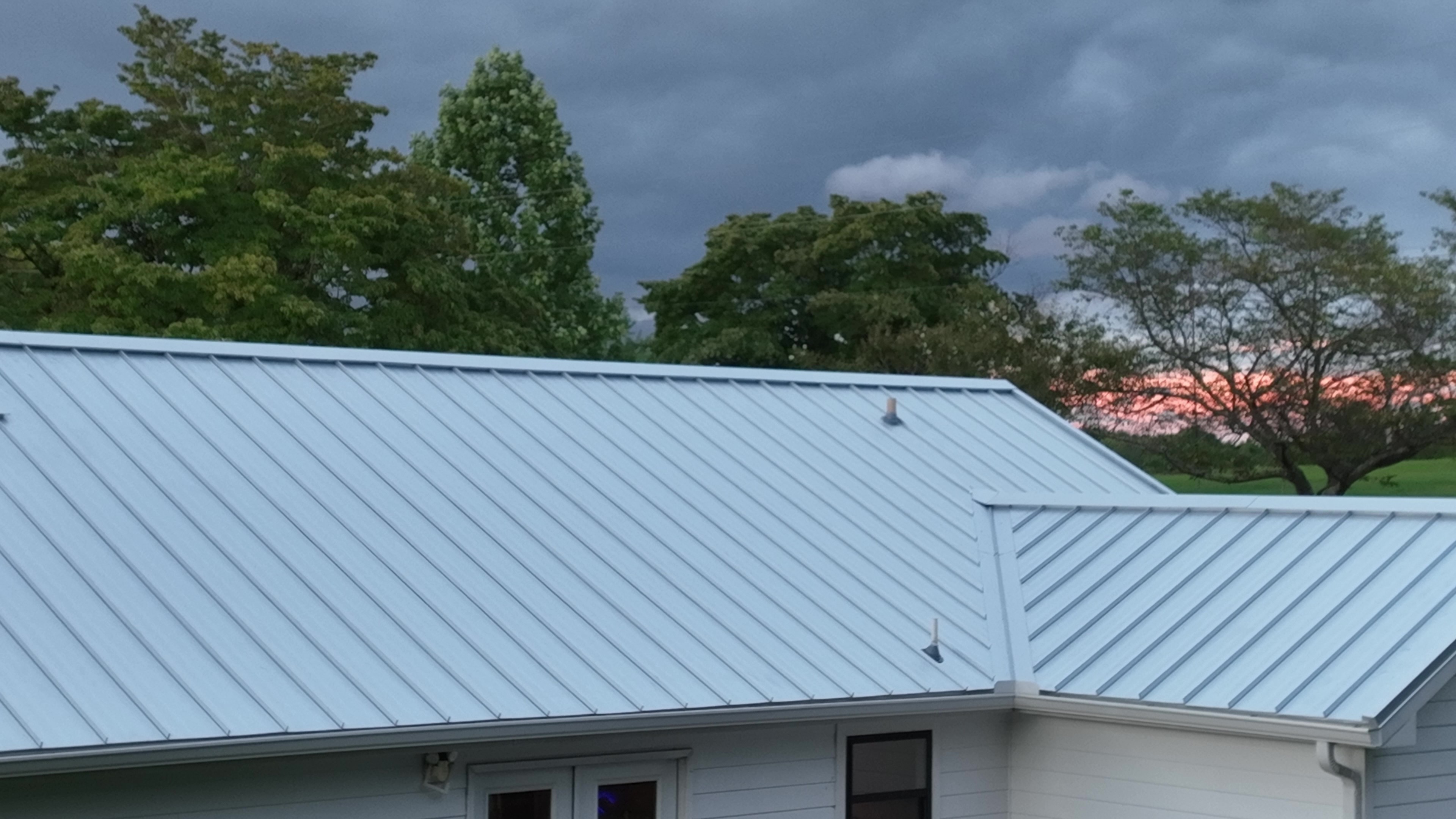 White standing seam metal roof panels under storm clouds in Ashland City, Tennessee