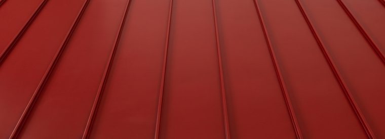 Red standing seam metal roof panels with concealed fasteners installed in Nashville