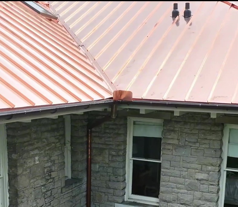 New copper standing seam roof installed on a stone home in Nashville