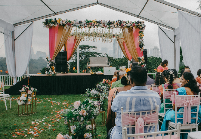 A garden wedding at Whitehouse @ The Estate, showcasing a setup under a tent as a practical backup plan for unpredictable weather.