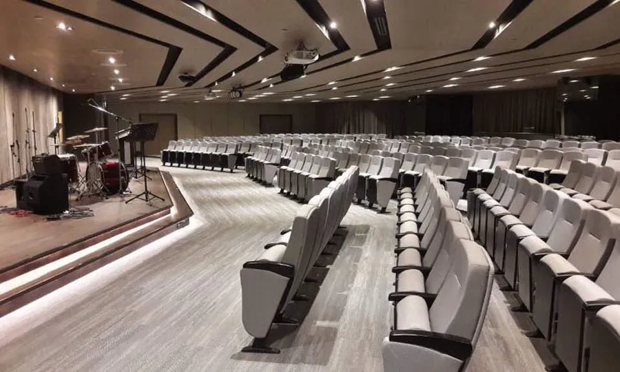 The modern interior of The One Auditorium, showcasing a space with rows of seating and a stage perfect for seminars and conferences.