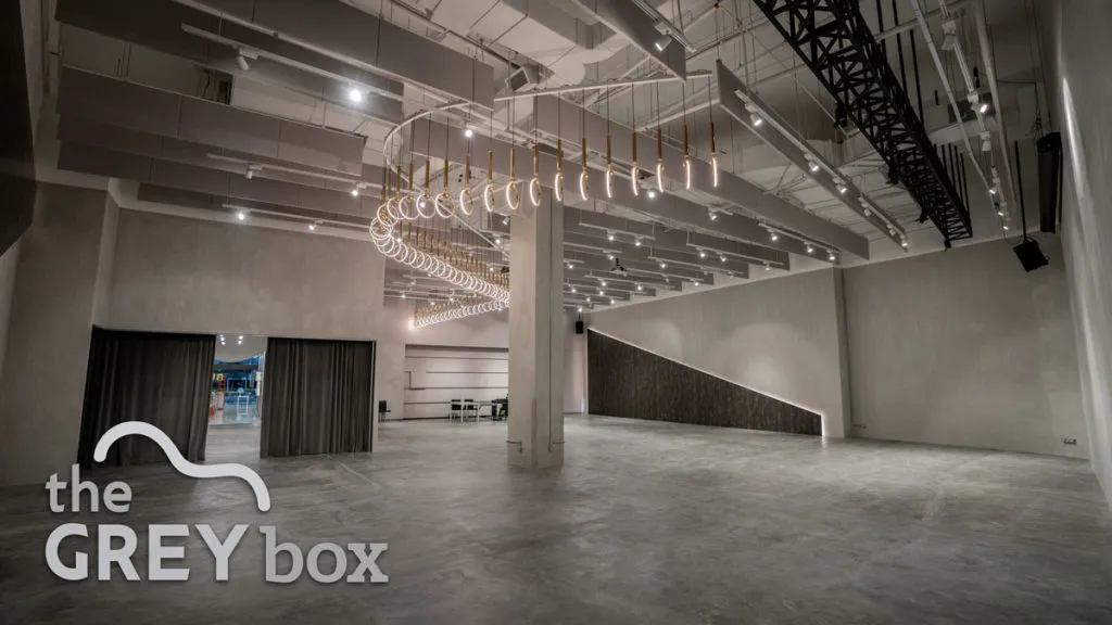 The empty interior of The Grey Box (GMBB), showcasing its industrial-chic design and open floor plan for creative events.
