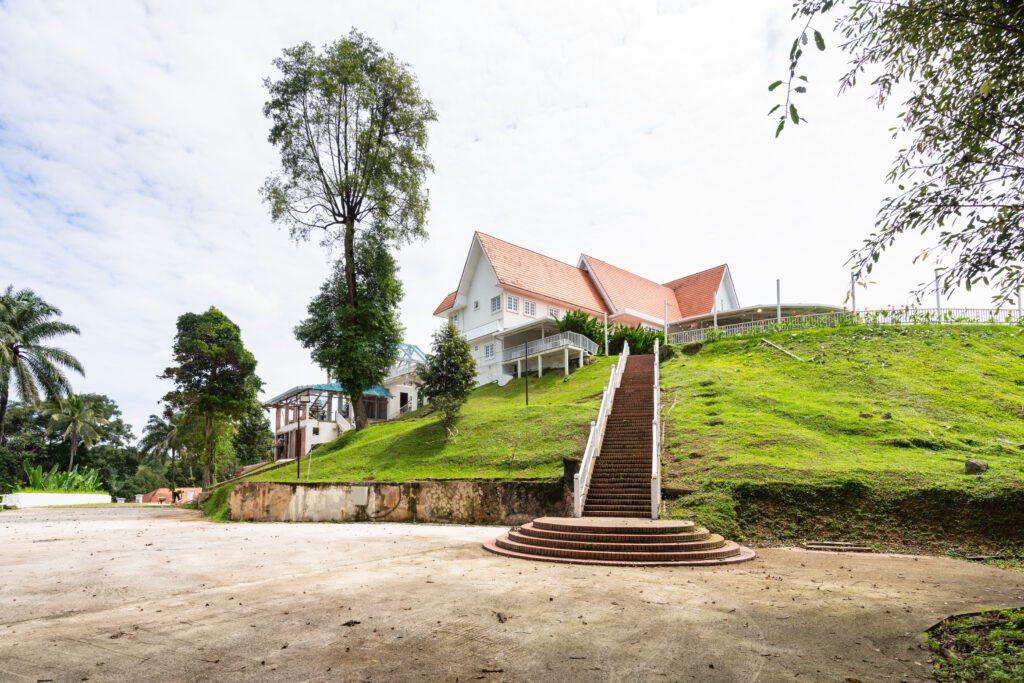 A wide view of Whitehouse @ The Estate on Federal Hill, showing the grand staircase leading up to the colonial-style building.